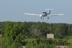 My Mom shot this photo of me landing at Holland Landing Airpark (CNA4). The 1960ft paved runway is great short-field practice. The plane is a Diamond Katana, belonging to National Flyers. June 2006 by Brigitte Vorkoetter.