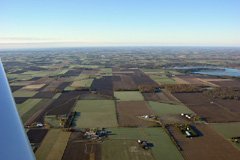 Ceiling and visibility unlimited over the farmland in our neighbourhood. The world looks at the same time big and small when viewed from the air. October 2005.