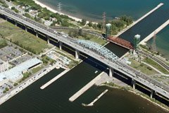 The Burlington Skyway cuts across the harbour at Hamilton Ontario. When driving, the Skyway looks tall and the road is steep. From the air it looks tall, but not nearly as steep.