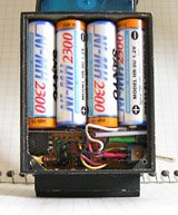 The power supply box holds the battery (top), circuit board (left), and switch and charging jack (right).