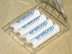 A set of four Sanyo Eneloop AA cells in their reusable storage pack.