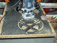 Using a router to enlarge the 8-inch speaker opening.