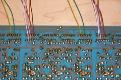 Wires from the ICs in each existing note block provide inputs for the new note circuits.