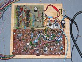 Rhythm generator, power supply, and sound board on a plywood base.