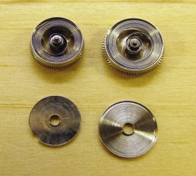 The alarm and clock mainspring barrels, opened for cleaning and oiling.