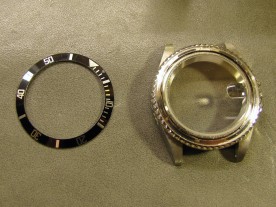 I removed the bezel insert by sliding two knife blades under it, revealing the bezel retaining spring.