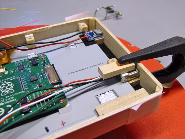 The micro-USB charging port (top) was screwed to a frame spacer, and the full-sized USB port (right) was epoxied to another spacer.