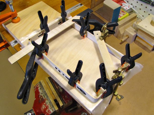 5x5x10mm mounting blocks were glued to the inside of the frame, flush with the back.