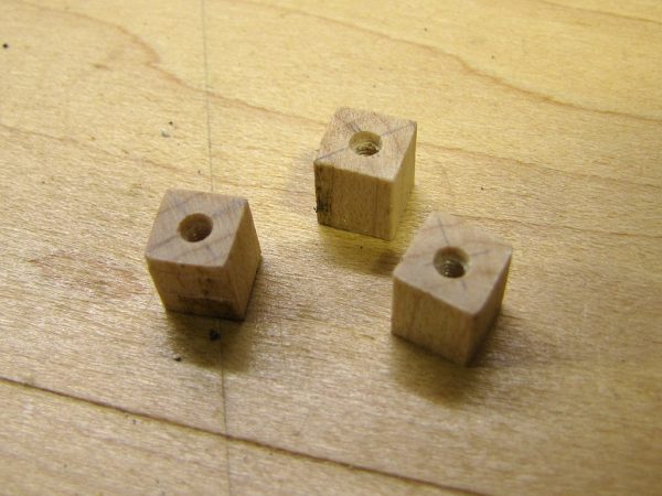 The 5 x 5 x 8mm maple blocks were drilled with a 2mm bit, and threaded using an M2.5 screw.