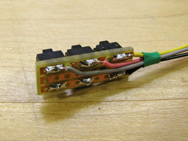 Three wires lead to GPIO pins on the Pi, and the fourth black wire connects to ground.