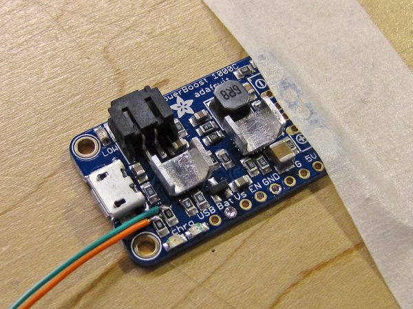 I attached homemade heat sinks to the charging and power conversion chips. The orange and green wires are to allow the Pi to monitor charging status.