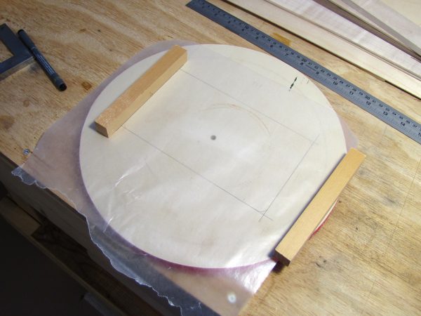 The jig was constructed on a piece of very flat plywood. The wax paper is to prevent the frame from sticking to the jig.