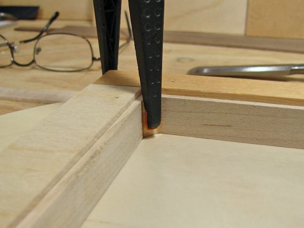 After the corner joints cured, excess epoxy was chiseled off, and the corners reinforced with triangular blocking.