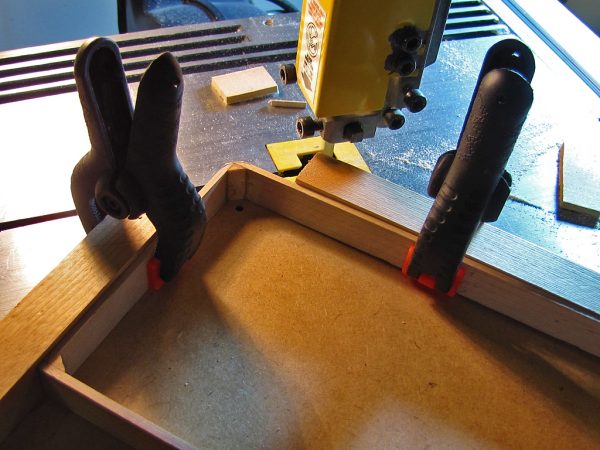 I constructed another jig to hold the frame for rounding the corners, first by cutting them roughly to shape.