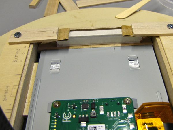 One spacer has already been installed (left), and another is held by clamps (top) while the epoxy cures.