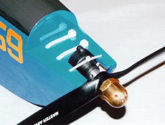 Two large cable ties bind the motor to the bottom of the <i>SlowPoke</i>'s glow engine mount. A thinner cable tie keeps the whole assembly from moving forwards.