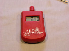 This GloBee tachometer can be set for 2-, 3-, and 4-bladed propellers. Here it is set for 3-blades, and is reading 240 to indicate 2,400 rpm (notice the "x10" label under the display). This reading is caused by the fluorescent lighting in my workshop.