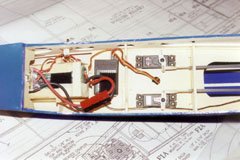 Bottom view of equipment installation. From left to right: ESC, battery box with battery, receiver, and servos. The tape holding the battery is temporary; I replaced it with a Velcro&reg; "seatbelt".