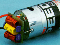 Photo 2. A capacitor-choke filter sold by Graupner, designed to be soldered directly to any 05-sized can motor, such as a Graupner Speed 600. Graupner also sells a Speed 400 sized filter.