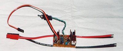 A home made electronic speed control (from the July 1999 issue). On the right are the leads to the motor. The arming switch is on the end of the twisted wires at the top. A pair of Sermos connectors terminates the battery leads.