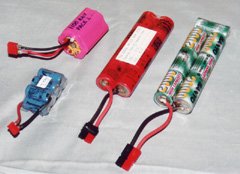 A variety of batteries. From left to right: a 7-cell pack of Panasonic 300 mAh cells for a Speed 280 pattern plane; a 7-cell pack of Sanyo 1100AAU cells for a Speed 400 sport plane; an 8-cell pack of Sanyo 1000SCR cells for a 2-meter sailplane; and a typical 7-cell pack of Sanyo RC2000 cells for a variety of planes.
