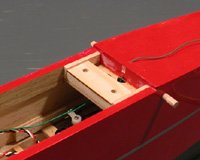 A 1/4" light balsa block with a 1/16" ply face guides the bolts down to the wing hold-down plate.