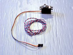 In a concession to mass production, modern servos like this Hitec HS-81 have flat parallel leads. Older servos used twisted leads like this vintage Ace R/C servo lead (center).