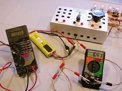 Using the left hand meter to measure the voltage difference across a connection (7.2mV), and the right hand meter to measure current (6.41A), we can compute the resistance of the connection to be 1.1 milliOhms. (0.0011 Ohms). Pins are used to tap into the wire on either side of the connection. The current is from the 7xCP2400SCR battery powering five paralleled automotive lamps (top right) through my bench top "speed control" (a large variable resistor).