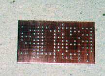 A clean, drilled, and deburred copper-clad board.