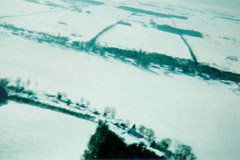 The view looking south, from about 800ft. The rectangular area at the bottom left is our back field. The large white band across the middle is the lake (you can faintly see the snowmobile trails in it). More farm fields stretch into the distance to the south.