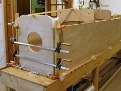 Fuselage sides clamped to firewall.