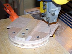 By rotating the platform, the saw cuts a perfect semi-circle out of the blanks.