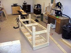The legs are added next, then the lower shelf framing.