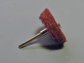 Brushing wheel cut from a Scotchbrite pad.