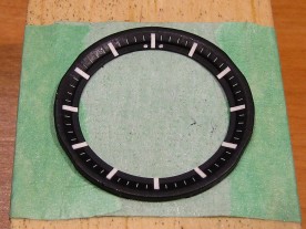 Completed chapter ring with hour indices and 12 o'clock lume dots.