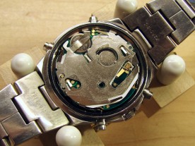 The movement reinstalled in the watch, with clear plastic insulating label.