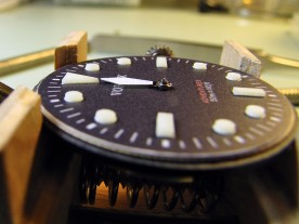 The hour hand would interfere with the 12 o'clock index if either were any longer.