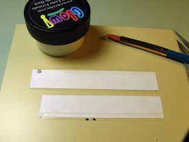 Two strips of adhesive label, and a jar of water-based luminous paint.