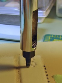 Using the punch to cut circular luminous indices.